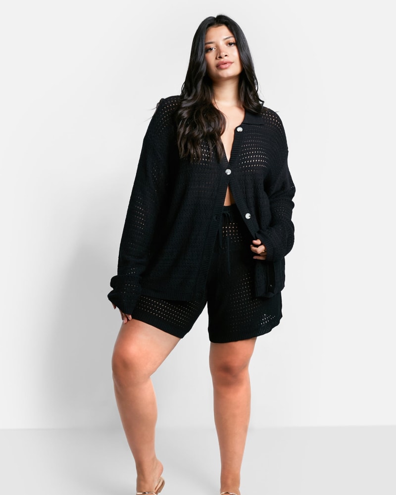 Front of a model wearing a size 1X Zuri Crochet Oversized Button Front Blouse in Black by Rebdolls. | dia_product_style_image_id:322162
